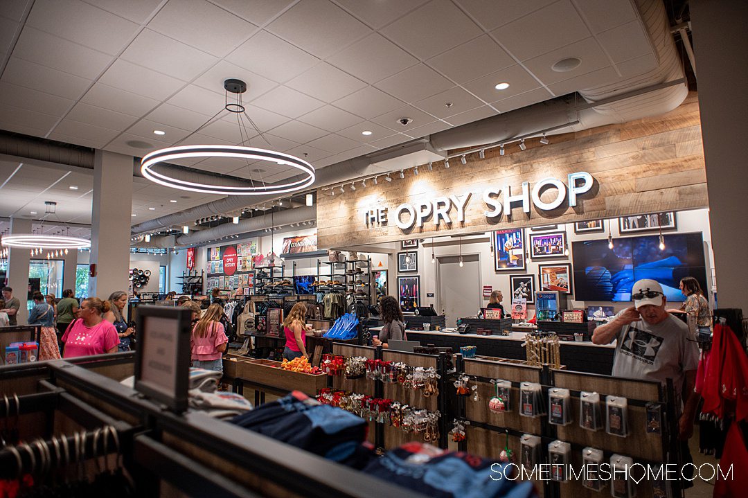 Inside the Grand Ole Opry gift shop with shelving, a light fixtures.