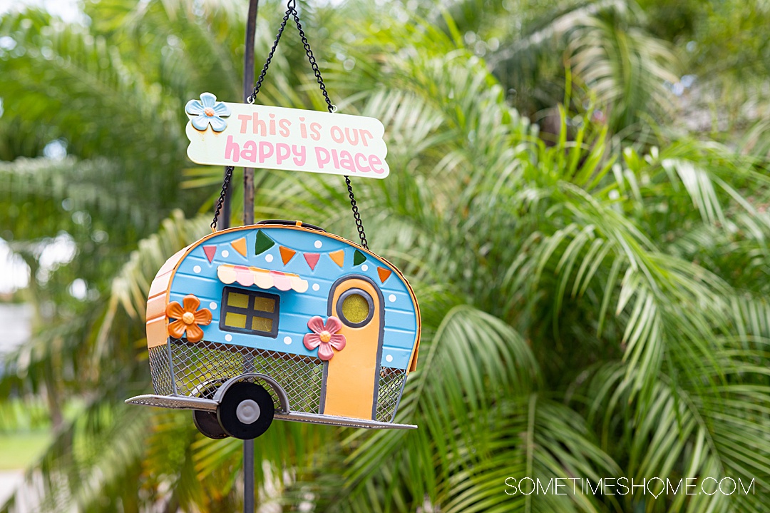 A little hanging RV trinket in front of palms for Trusted Housesitters in Florida.