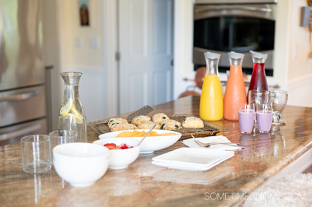 Breakfast bar with fresh juices and several serving bowls at Twin Islands Retreat in Alaska.