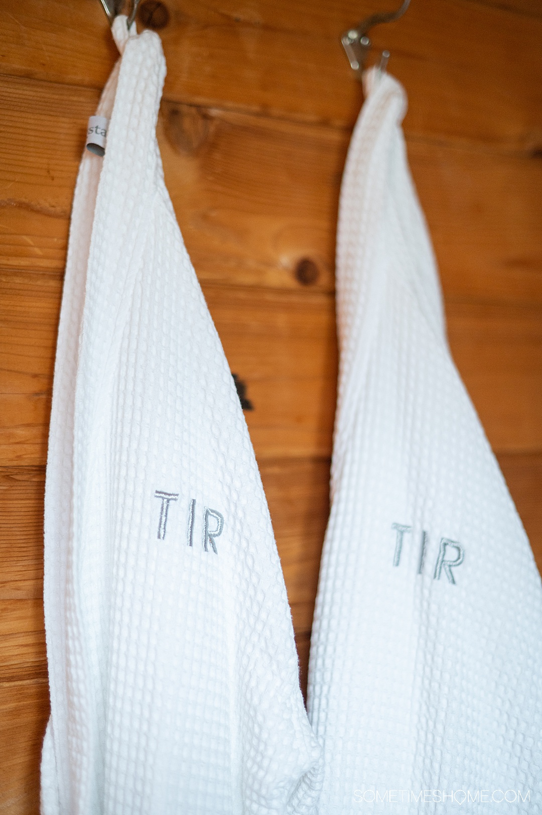 Two white bathrobes with "TIR" letters in the sauna at Twin Islands Retreat in Alaska.
