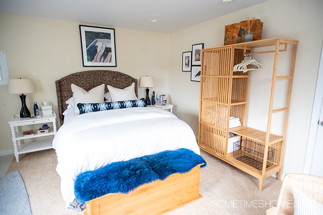 Queen bed with white and blue linens and bedding at Twin Islands Retreat for couples in Alaska.