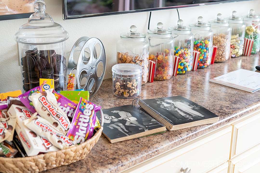 Candy jars lined up in a row on a shelf with a basket of candy on the left at Twin Islands Retreat.