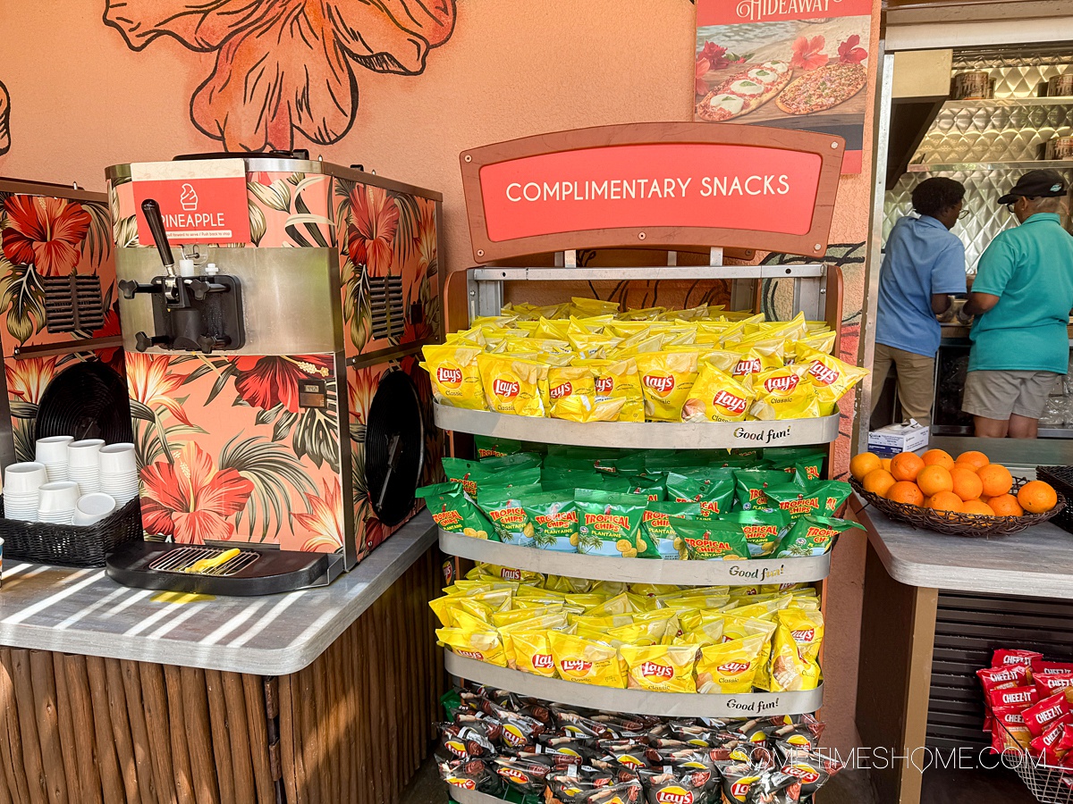 Display with potato chips and part of a drink machine to the left.