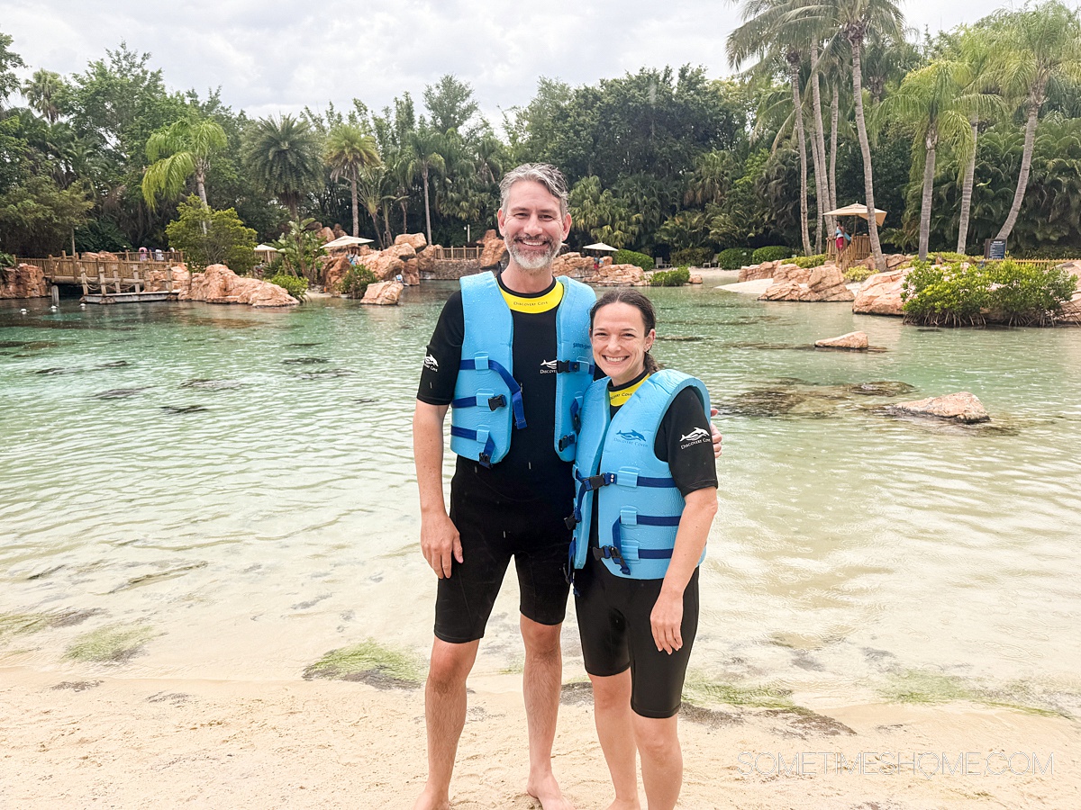 Couple in live vests and wet suits at Discovery Cove theme park in Central Florida.
