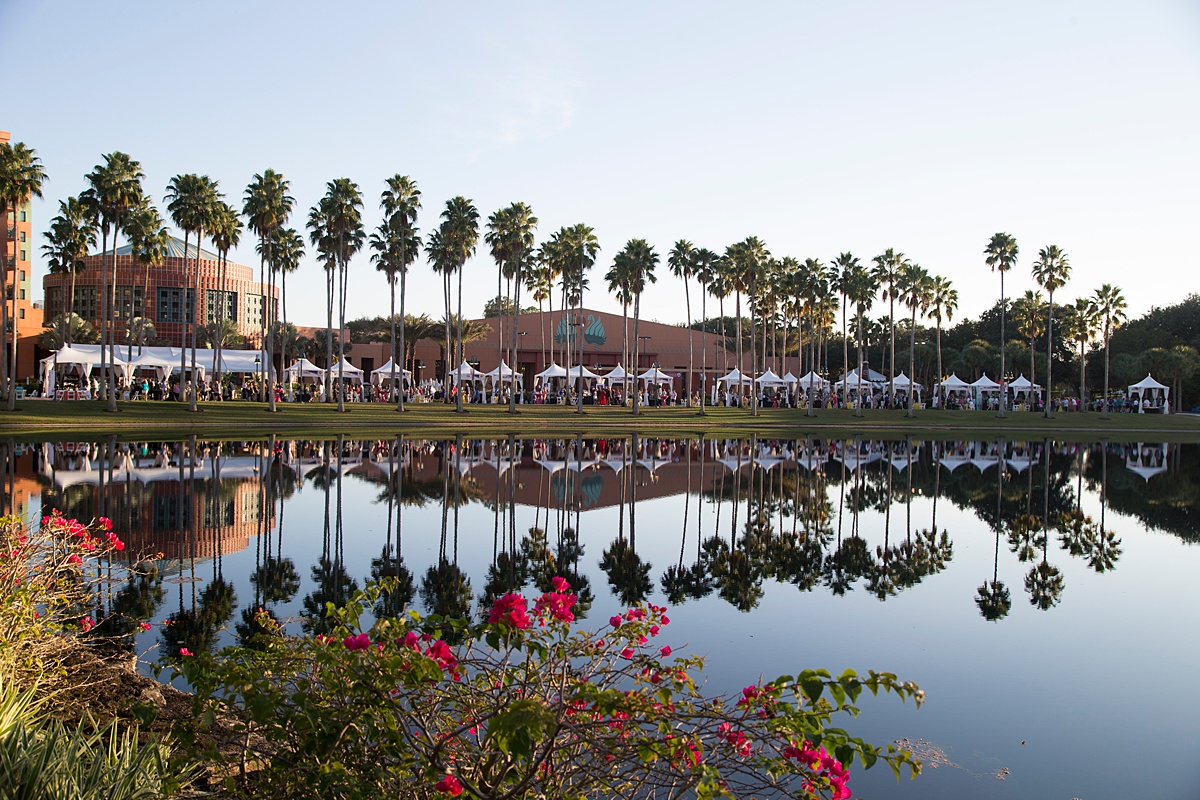 The Food and Wine Classic from afar with palm trees lining the water.