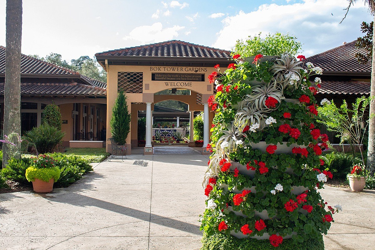 Bok Tower Gardens building in the background with a Christmas tree made of succulents and assorted plants for the holidays.