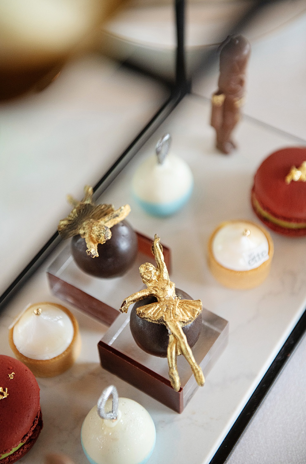 Close up of desserts for the Holiday Tea at ette Orlando with gold chocolate ballerinas on top.