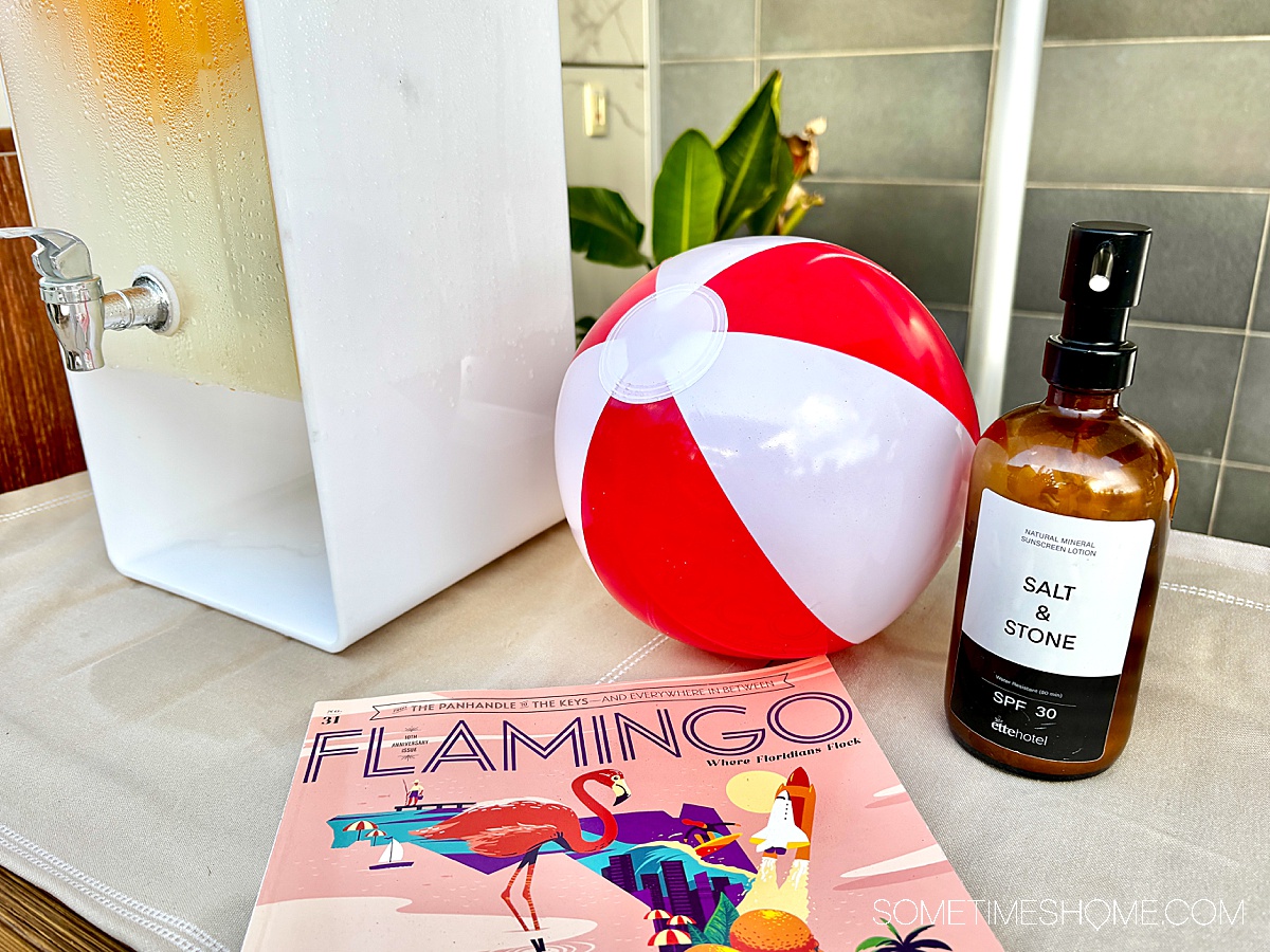 Beach ball next to sunscreen and a Flamingo magazine in Florida at the ette hotel.