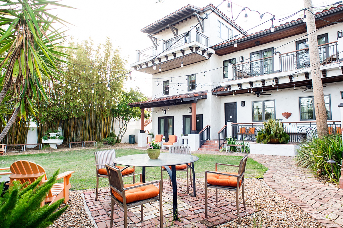 Courtyard area at a boutique hotel in New Smyrna Beach with a table and chairs.
