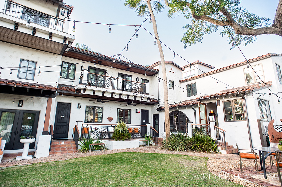 Multi-storied boutique hotel with a lawn in the back courtyard in New Smyrna Beach