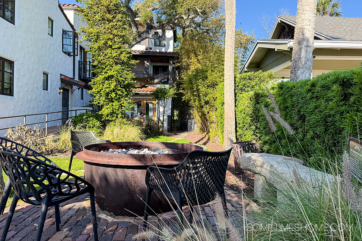 Fire pit in the guest area of the Black Dolphin Inn hotel, a boutique property in New Smyrna Beach, surrounded by lush greenery